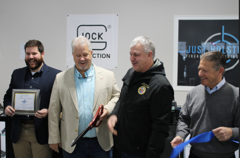 Legislator Malczewski presents a proclamation to the owners of Just Holster It