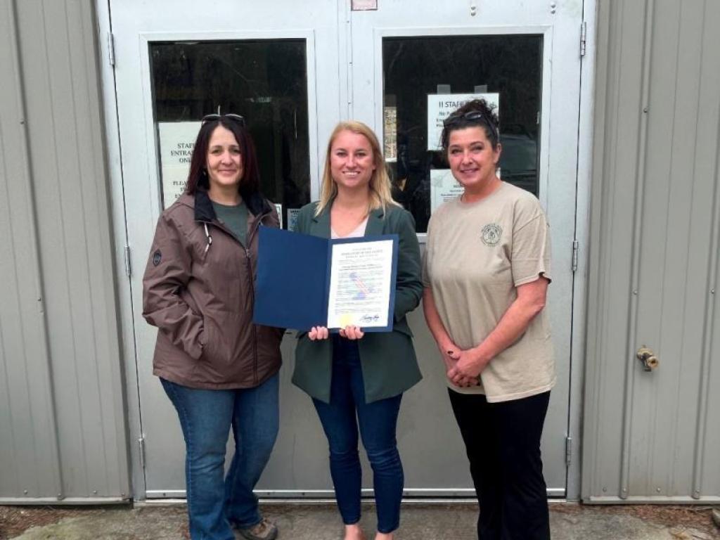 Erie County Legislator Lindsay Lorigo presents a proclamation to Jennifer Walker and Tina Miller, two of the approximately 300 volunteers who dedicate their time and expertise to wildlife rehabilitation at Messinger Woods Wildlife Care & Education Center