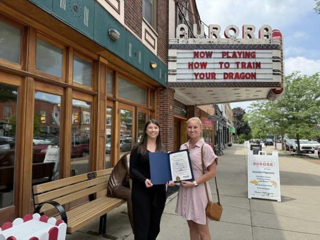 Legislator Lorigo presents proclamation to Aurora Theatre and Popcorn Shop on their 100th anniversary