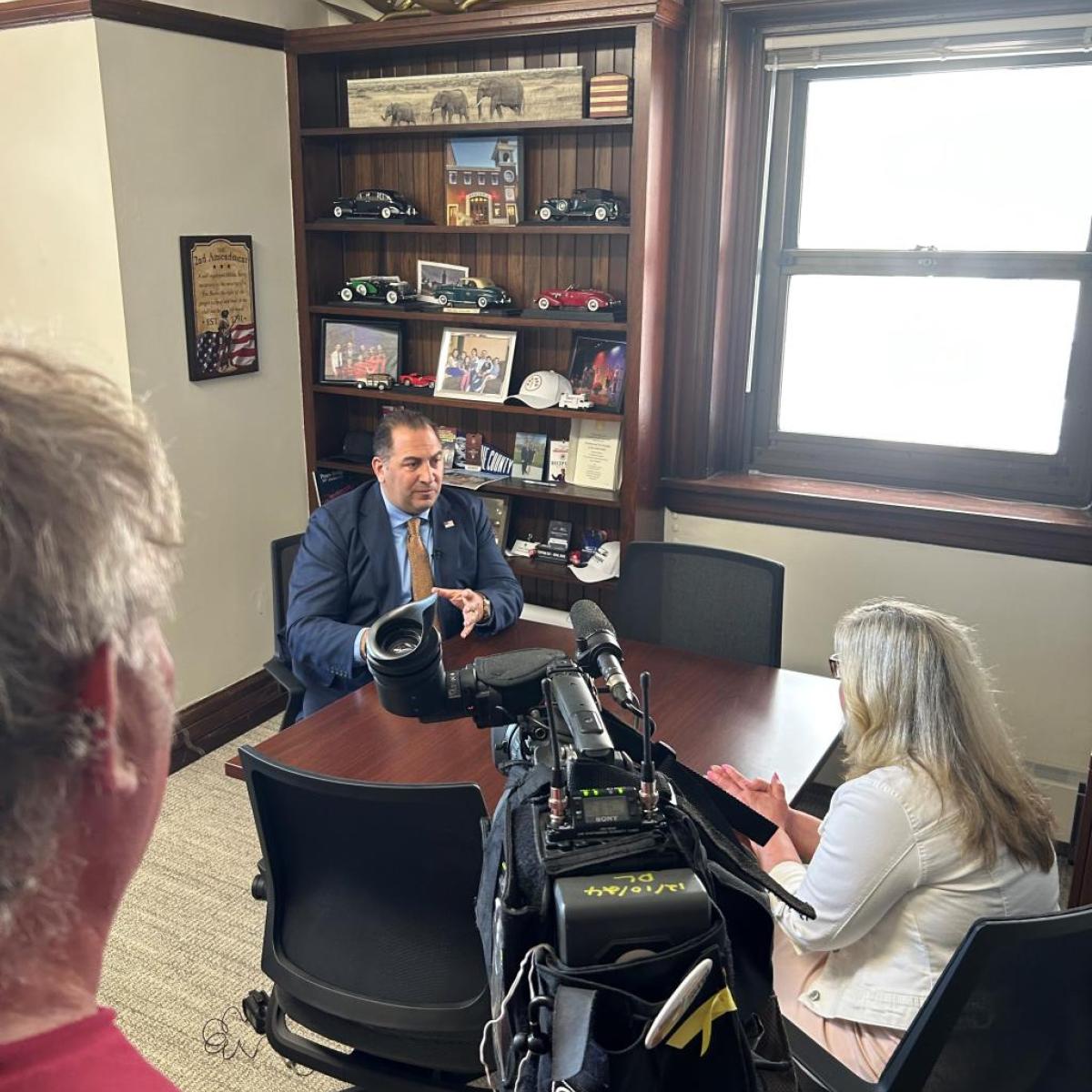 Legislator Todaro speaks with the media about the sale of the old Erie County home property