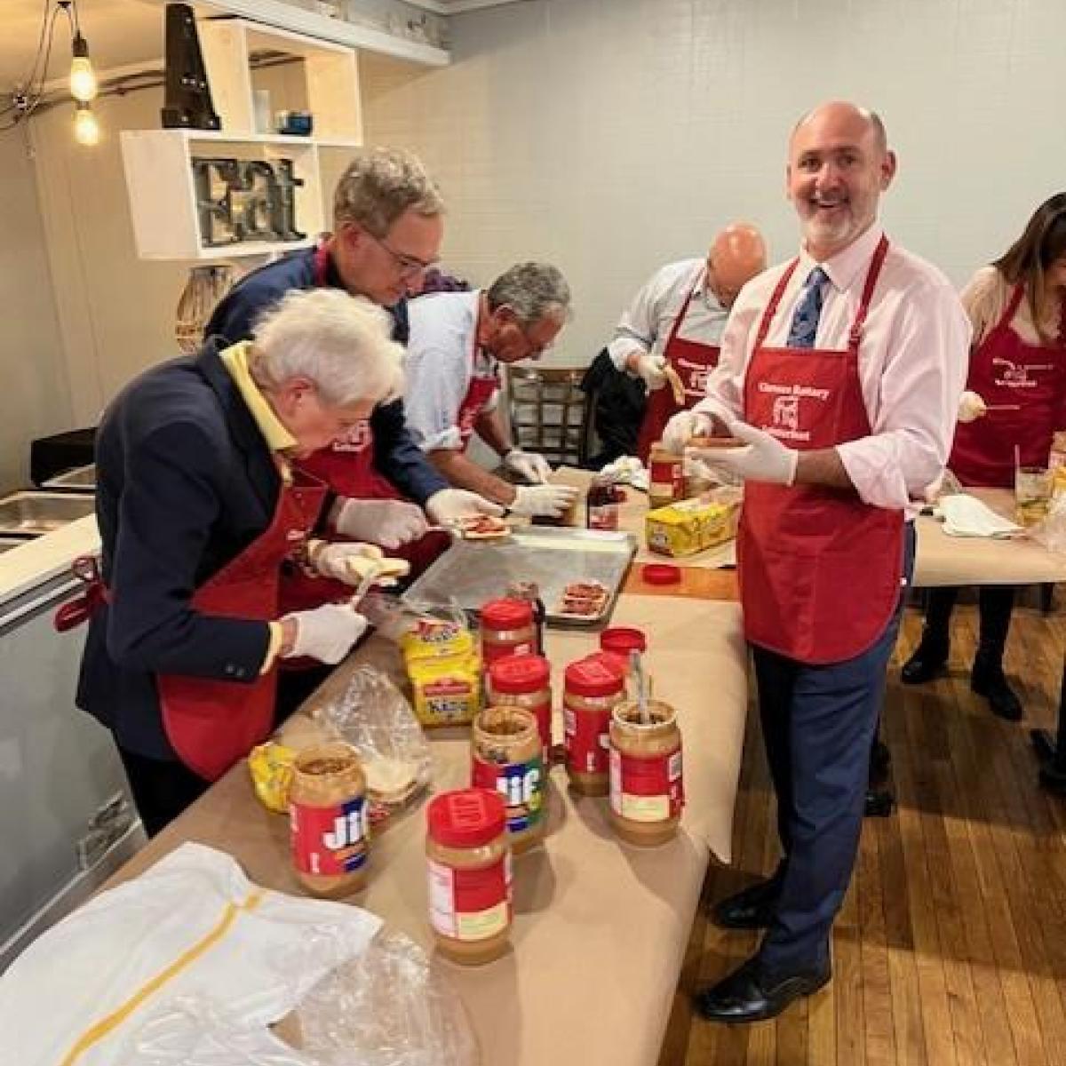 Legislator Chris Greene helps United Way make PB&J sandwiches for Friends of the Night People
