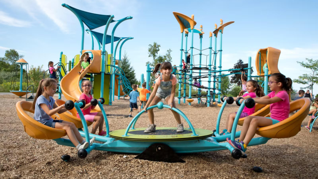 Children enjoying a twirler on an all inclusive playground.