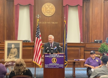 Erie County Clerk Michael P. Kearns pays tribute to the 2023 Purple Heart Recipients being added  to the William J. Donovan Purple Heart Book of Merit that is kept on permanent display in the  Erie County Clerk's Office during a Dedication and Flag Raising Ceremony that included honorees, family members,  area veterans, and the Military Order of the Purple Heart, Chapters 187 and 264.