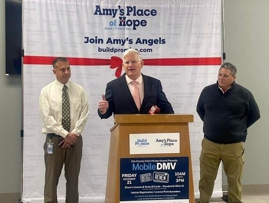 Clerk Mickey Kearns speaking at Build Promise Community Access Center during the first Mobile DMV event, providing access to IDs and community resources.