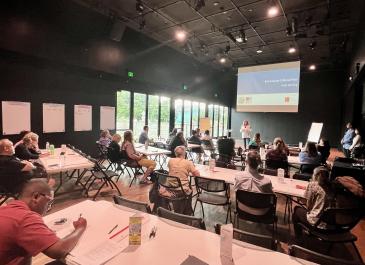 picture of public meeting 2 room and presentation from back