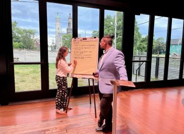 picture of public meeting 2 consultants taking notes