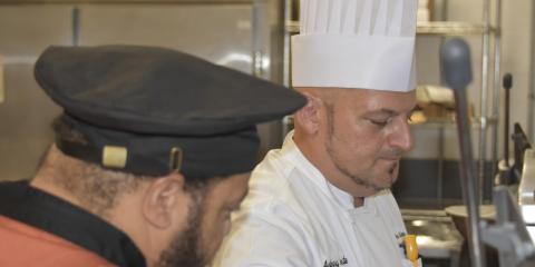 SUNY Buffalo State Culinary Lab Coordinator Don Schmitter assists a THRIVE Program participant