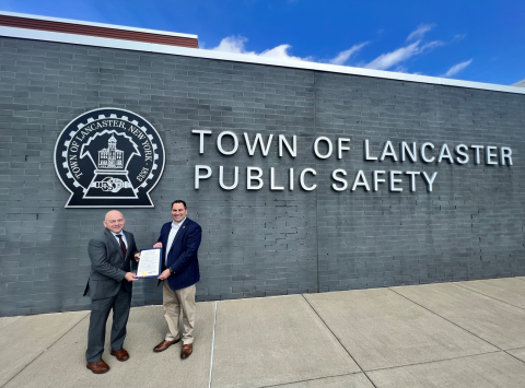 Erie County Legislator Frank Todaro presents a proclamation to retiring Lancaster Police Chief Karn